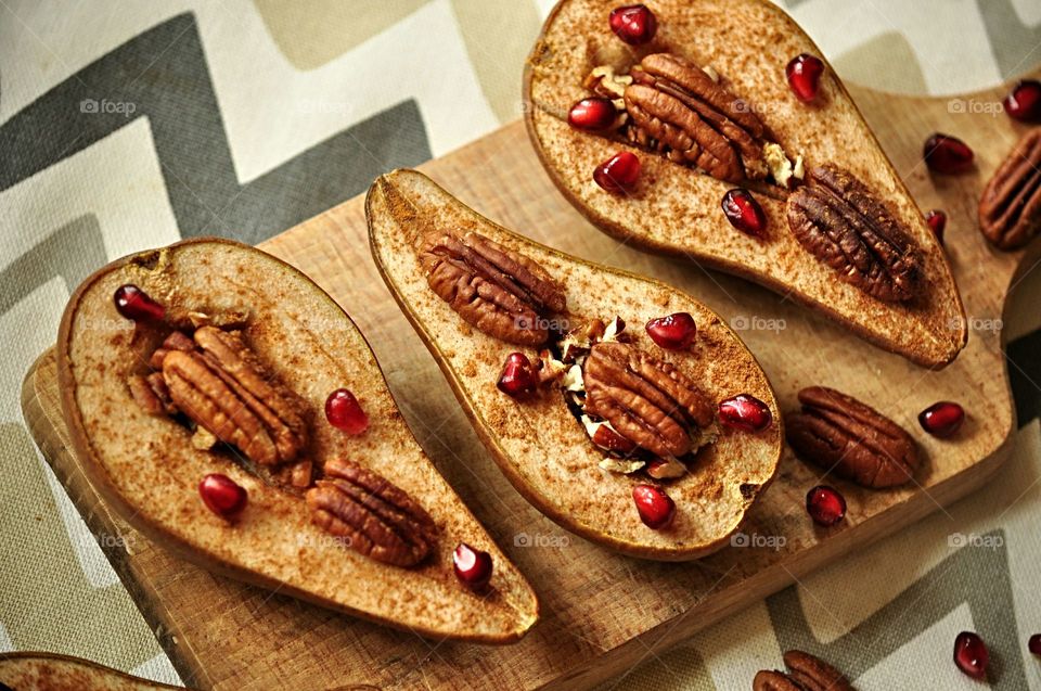 baked pears with cinnamon, pecans and pomegranate seeds