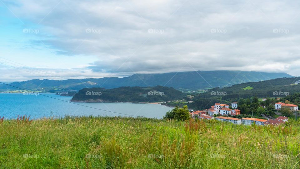 Panoramic view of the village of Lastres (Asturias). Scenic view of landscape, mountains, coast and Cantabric Sea. Lastres, Asturias, Spain.