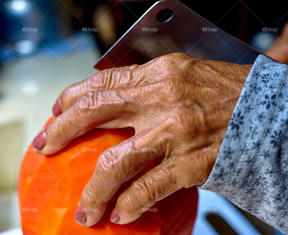 Preparing fresh and ripe papaya for salad