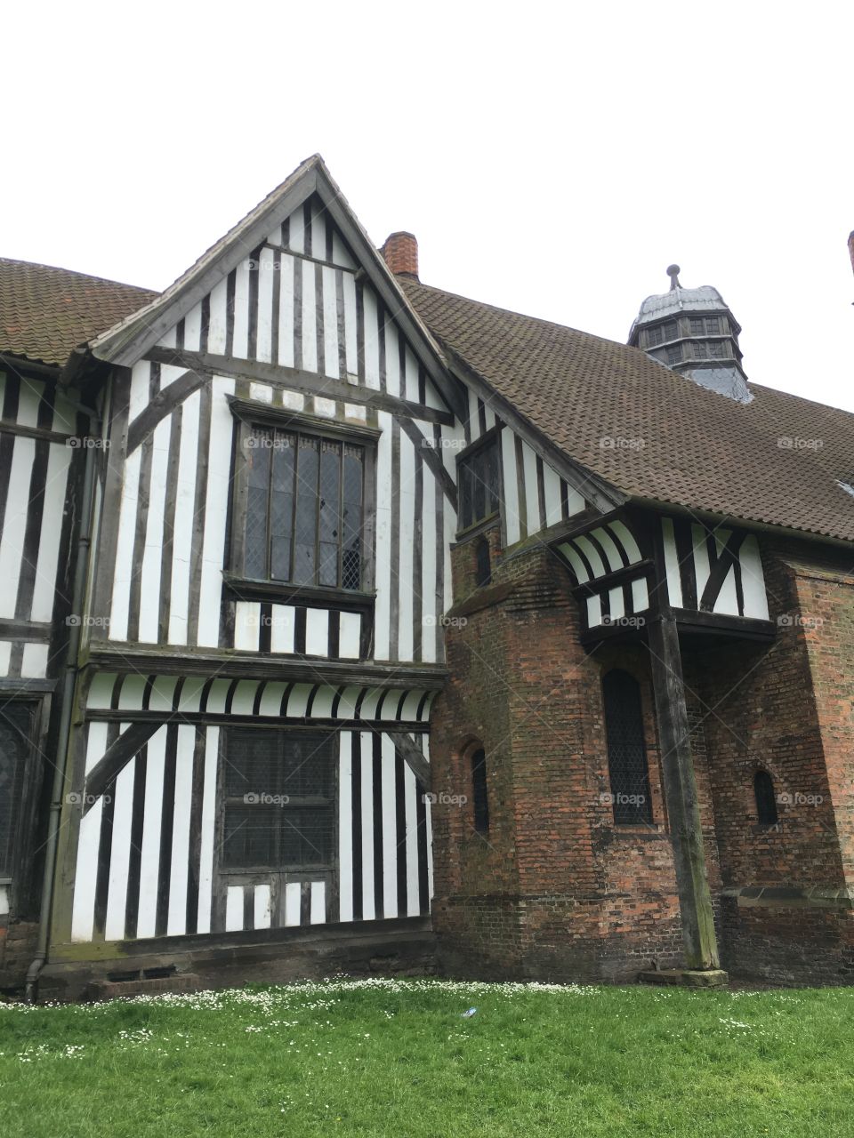 Exterior view of the medieval Manor House at Gainsborough Old Hall showing timber framework, windows, roofing and brickwork 
