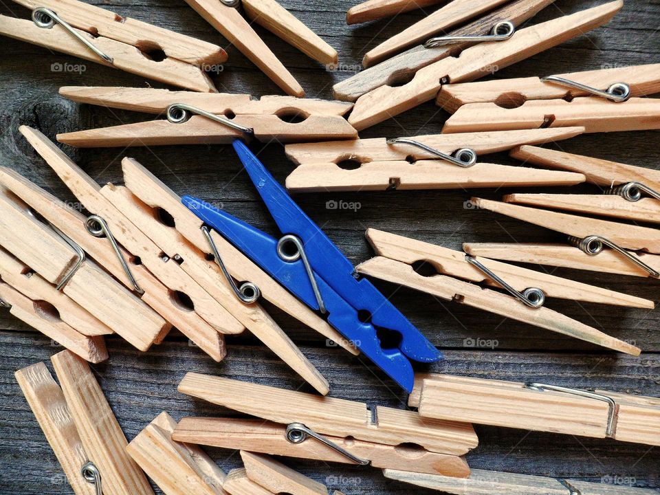 wooden clothespins and one plastic one for linen lie on the boards