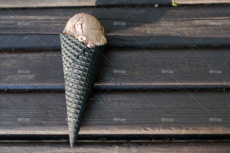 Chocolate ice cream on wooden bench