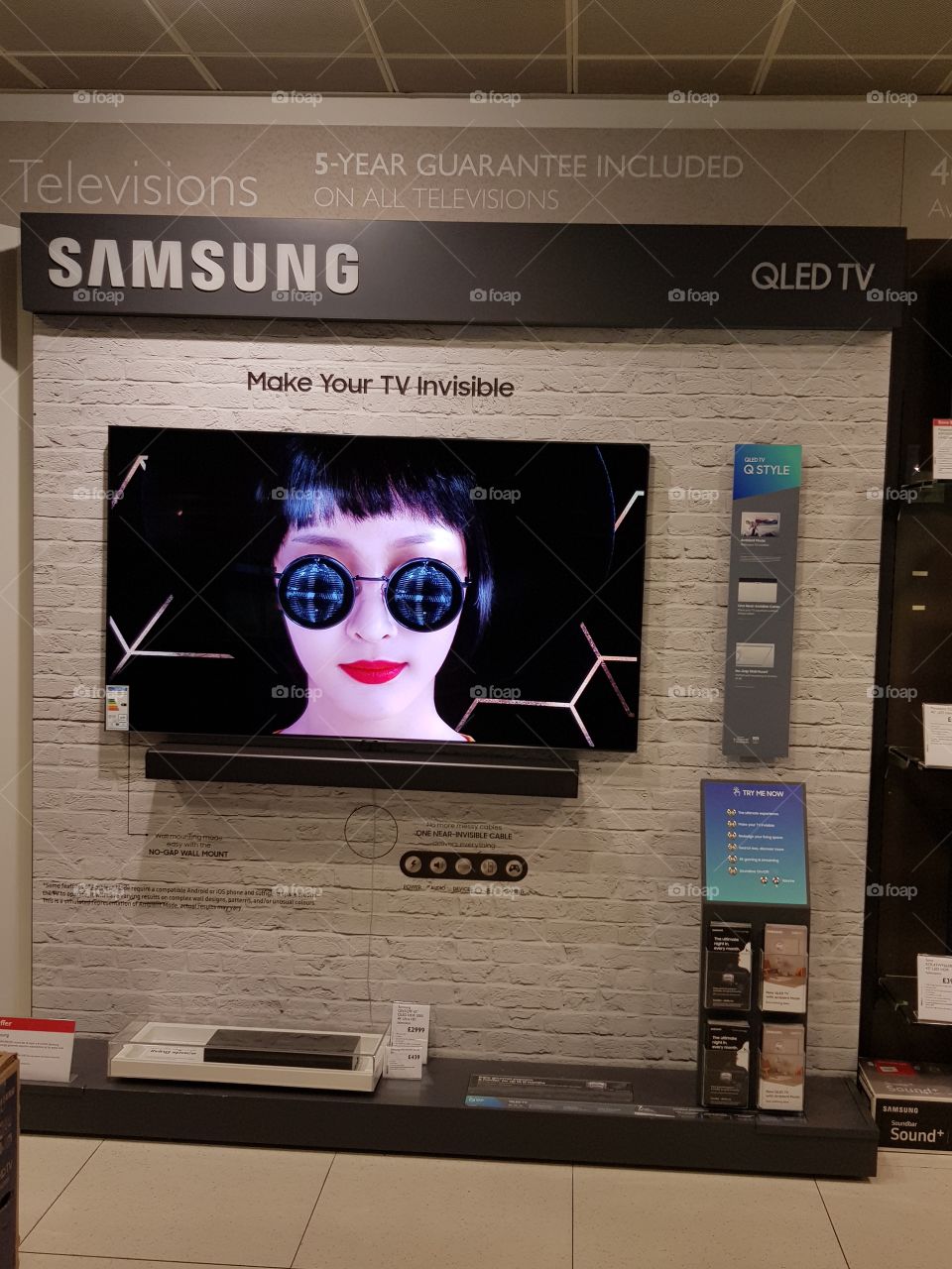 Samsung 4K UHD QLED television with soundbar on display wall at Peter Jones Sloane square Chelsea King's road London