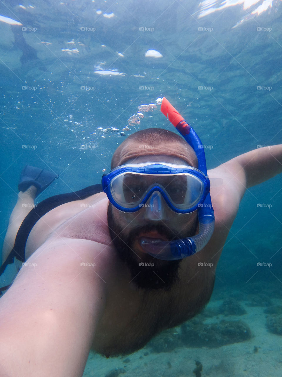 snorkling underwater. man is snorkling underwater with mask