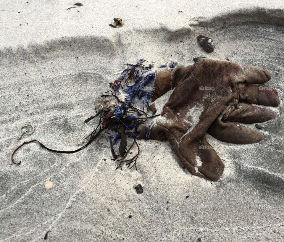 Elevated view of glove on sandy beach