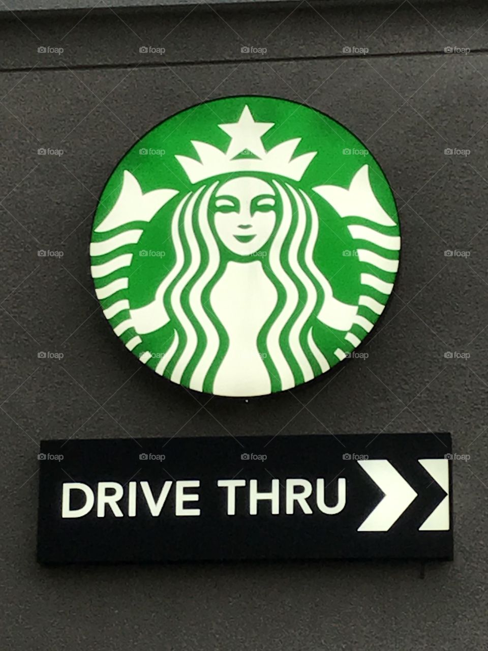 Starbucks drive-thru. A fine view of the coffee shop’s large logo and sign.