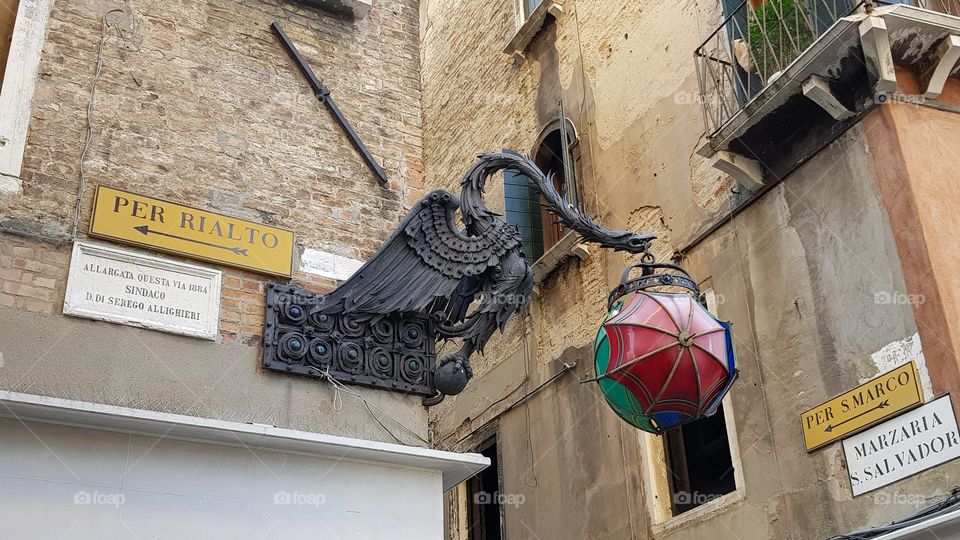 Street lamp in Venice in the shape of a Phœnix carrying the world in the shape of umbrellas