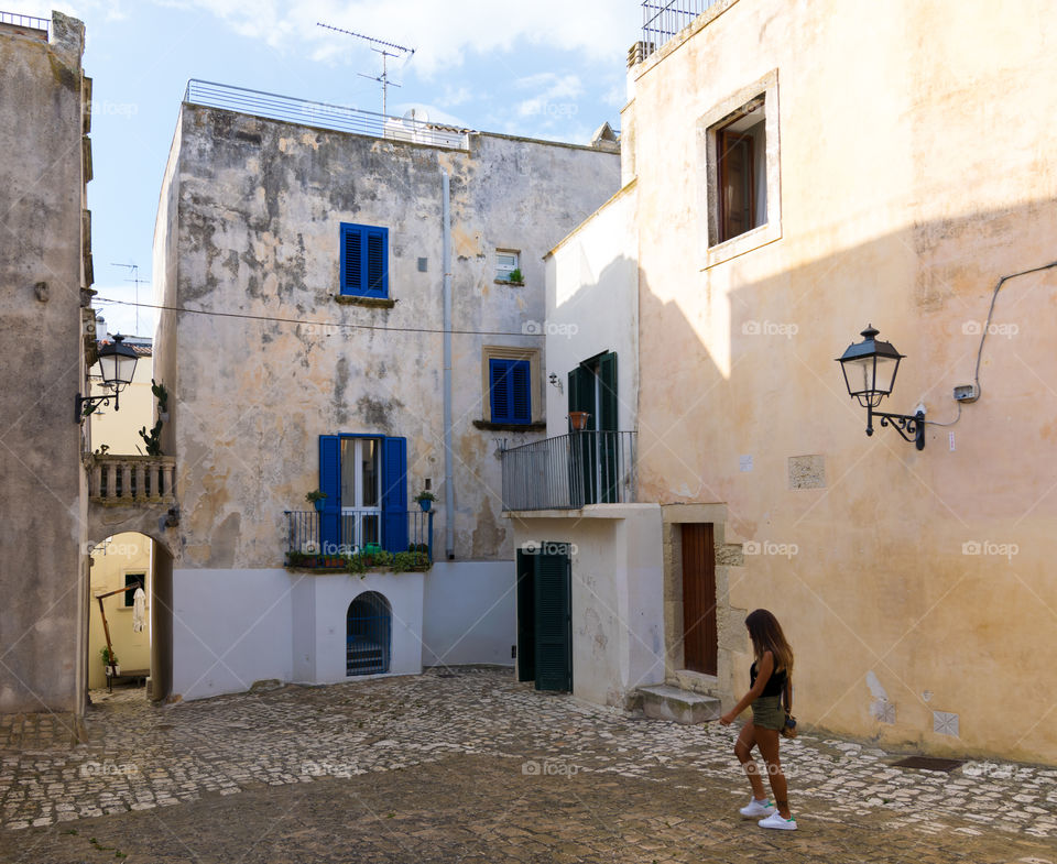 Rear view of woman walking on street