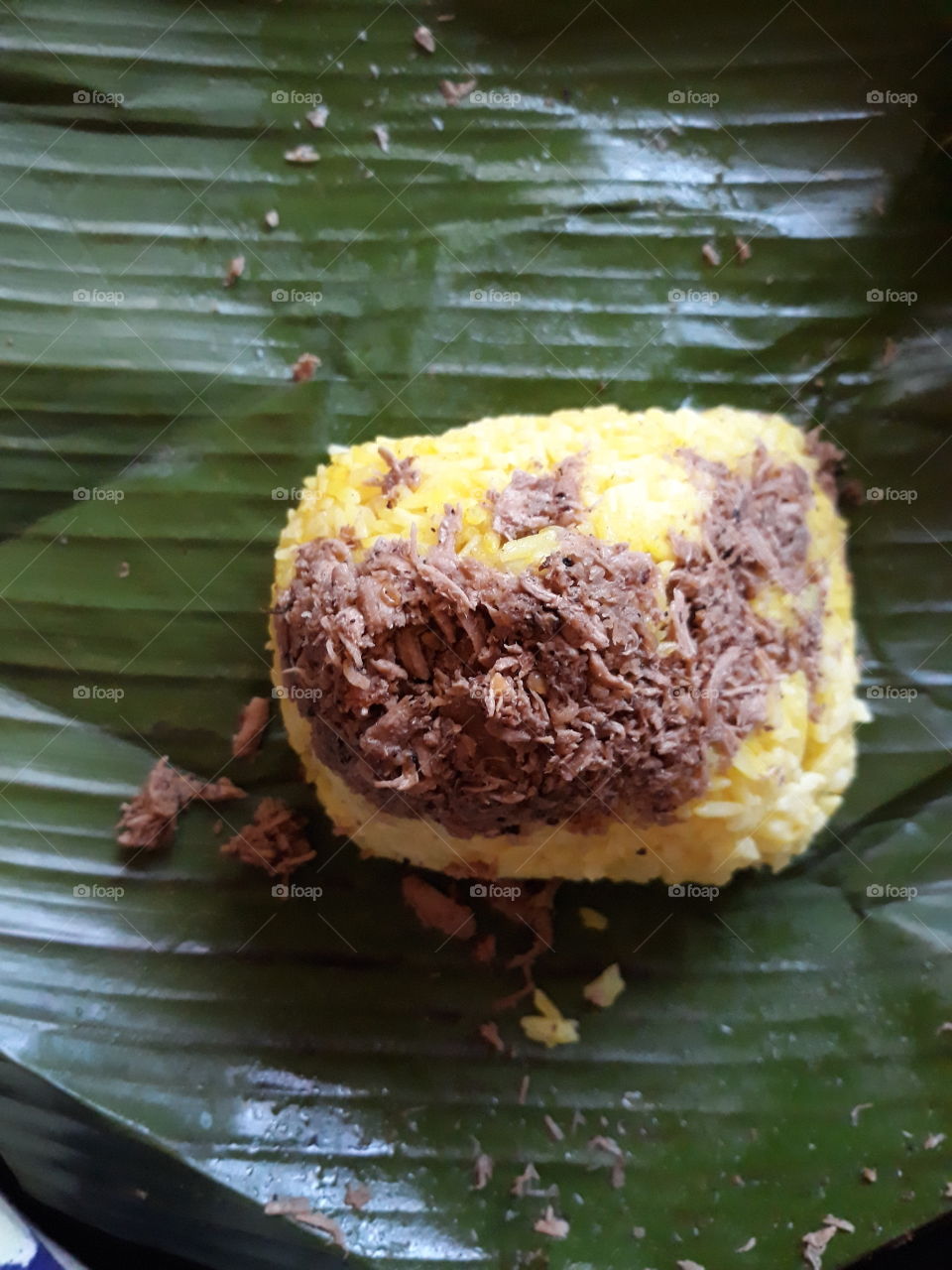 Hot and spicy version of Chicken Pastil or Chicken Pater, rice delicacy from the Maranao tribe in the Philippines, topped with grilled chicken breast and browned coconut milk and wrapped in banana leaves.