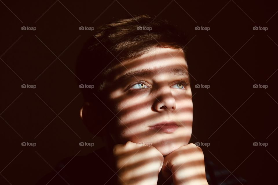 Close up portrait shot of my nephew looking away from camera (light&shadow)