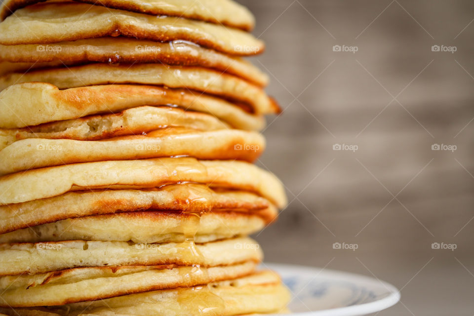 Pile of freshly made golden pancakes on a plate