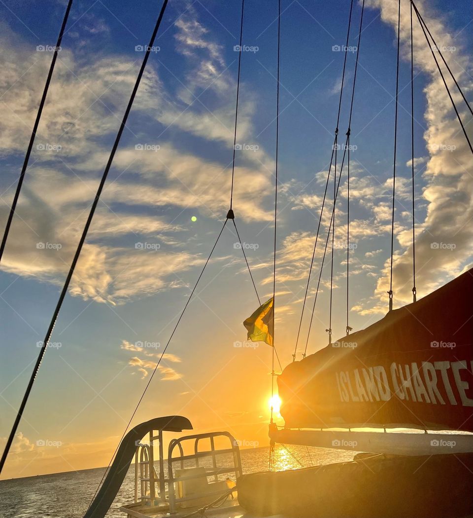 Capturing the last few rays of sunlight as the sunsets over the Caribbean while floating along the smooth sea in a beautiful catamaran