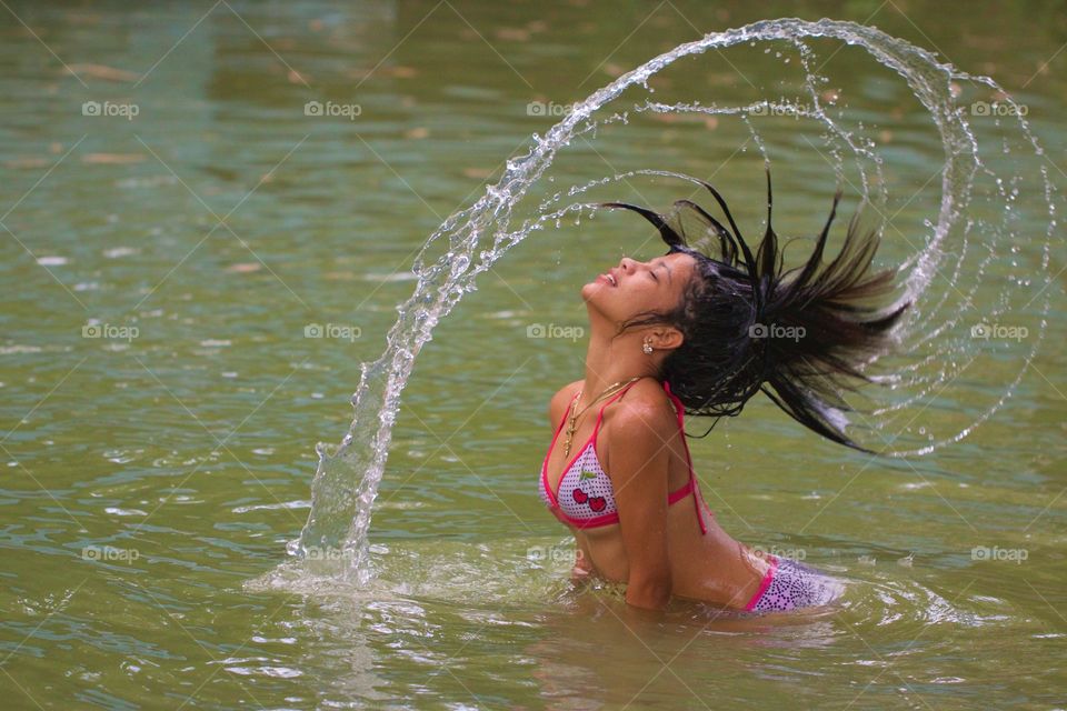 Beautiful Girl Splashing The Water With Her Hair