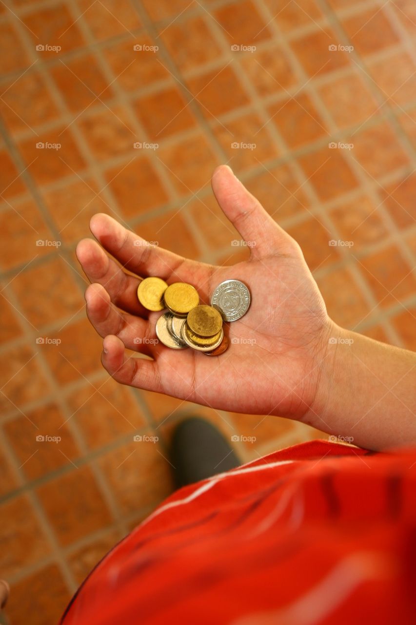 person holding coins in his hand