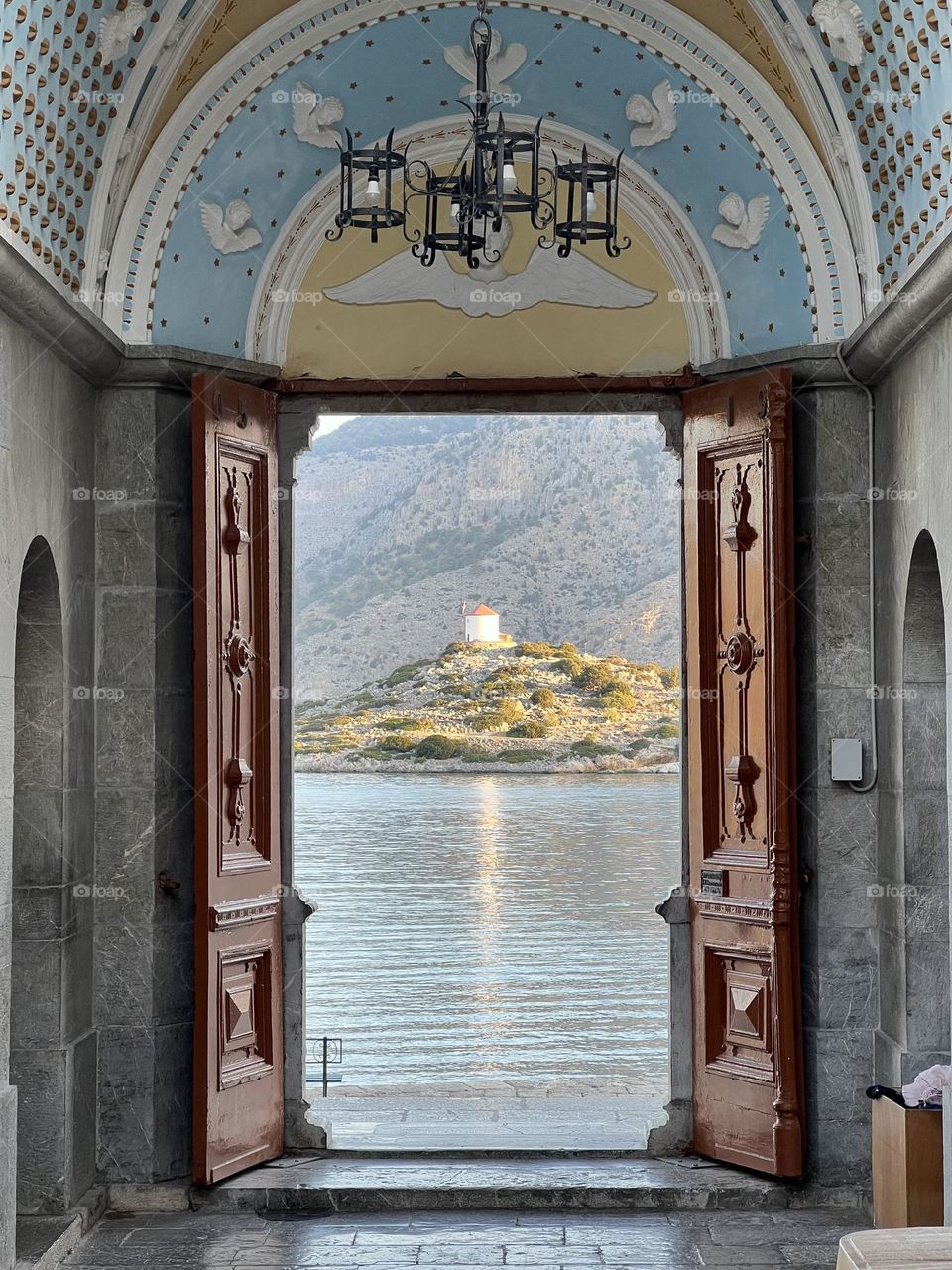 A small mill through the gate of Saint Michael in Panormitis, Symi.