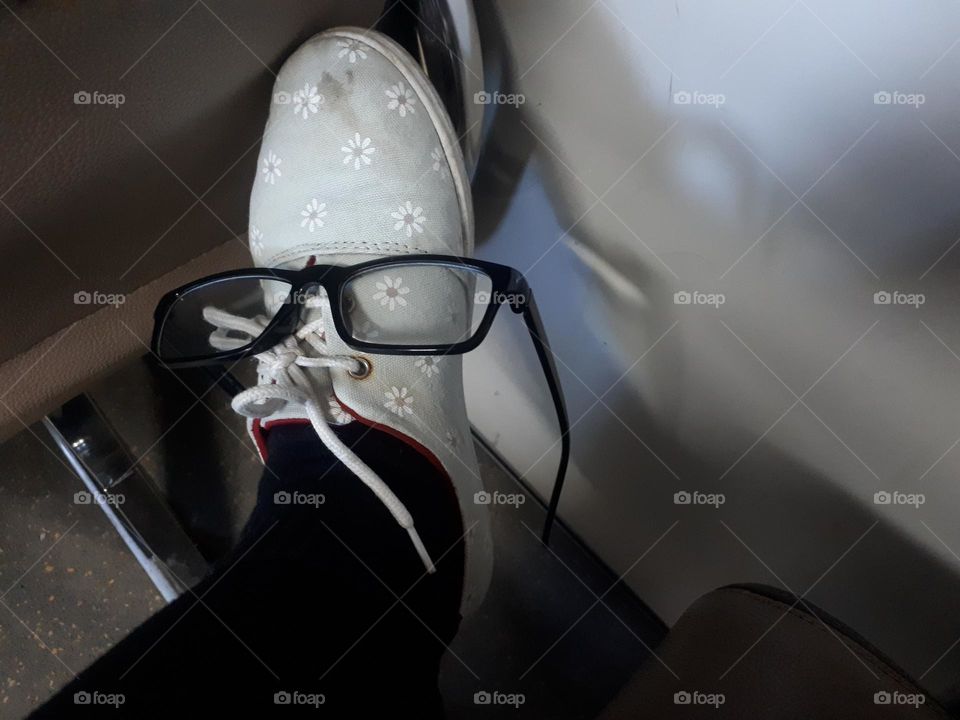 shoes with floral designs decorated with cute glasses as accessories on the train