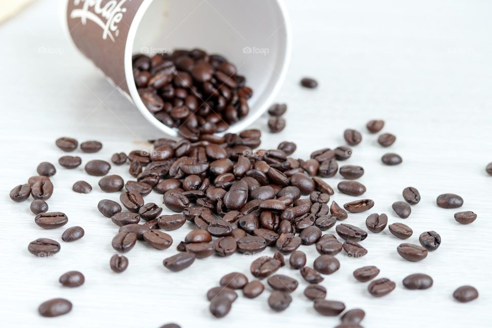 Coffee beans in a paper cup