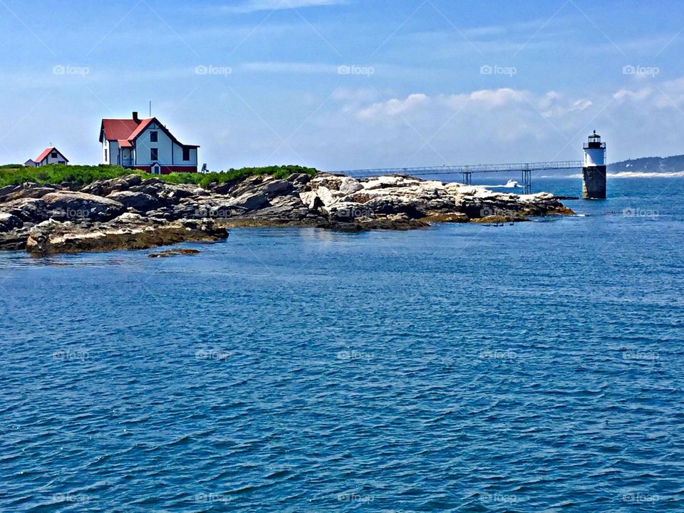 This Maine conical lighthouse is approached by a winding footpath through a quiet, sheltered forest, making the contrasting roar of the waves 