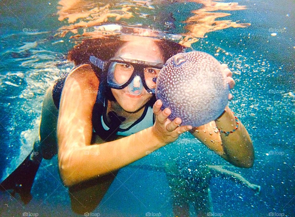 Woman holding fish in water