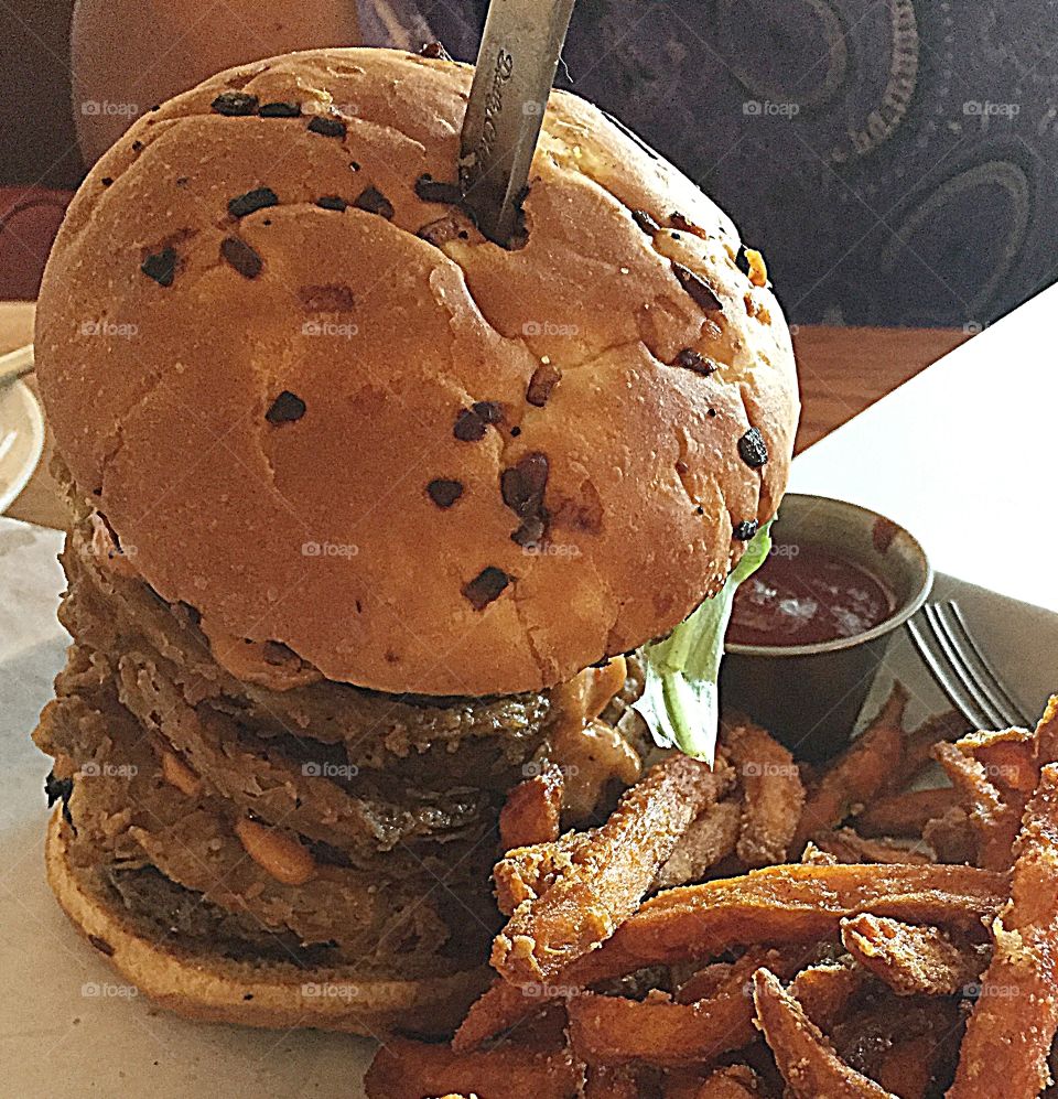 My favorite sandwich - giant hamburger with onion rings and sweet potato fries