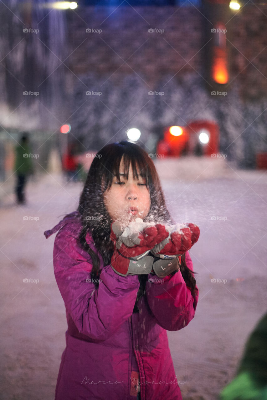 Girl blowing artificial snow