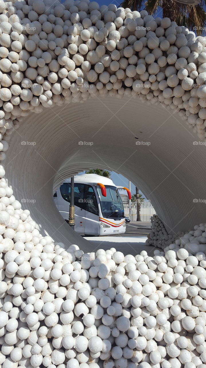 Bus behind sculpture