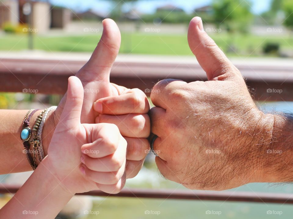 Family with thumbs up