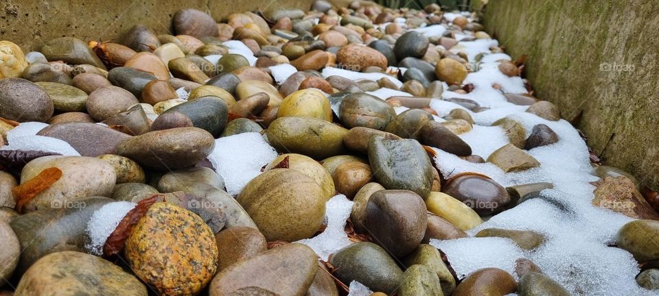 shiney snow covered pebbles and rocks