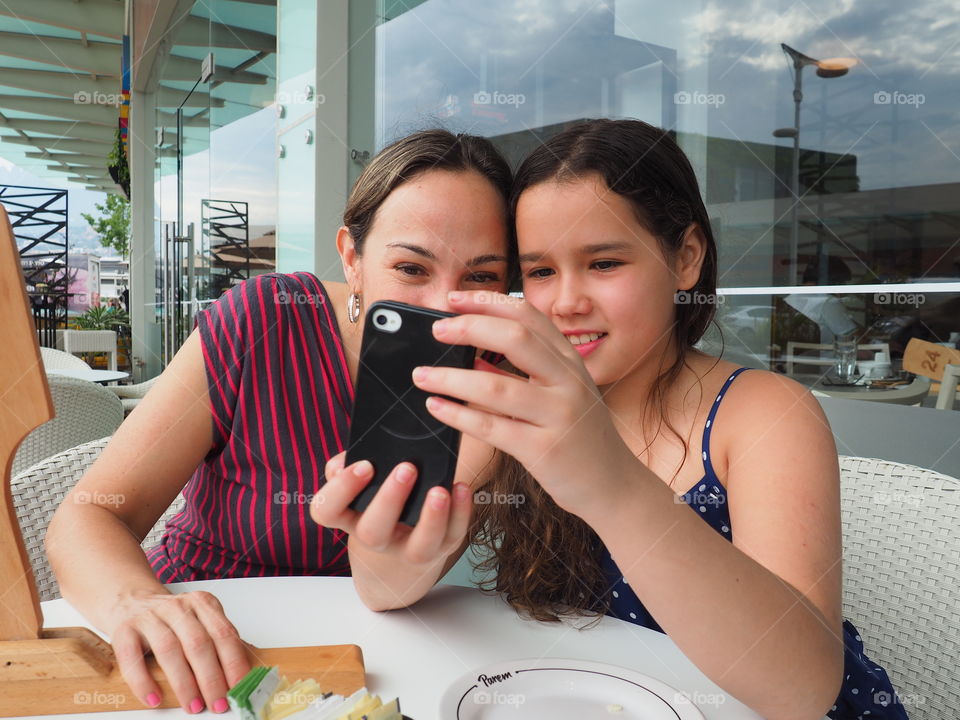 Mother and daughter browsing. Mother and daughter surfing and browsing the internet and having fun