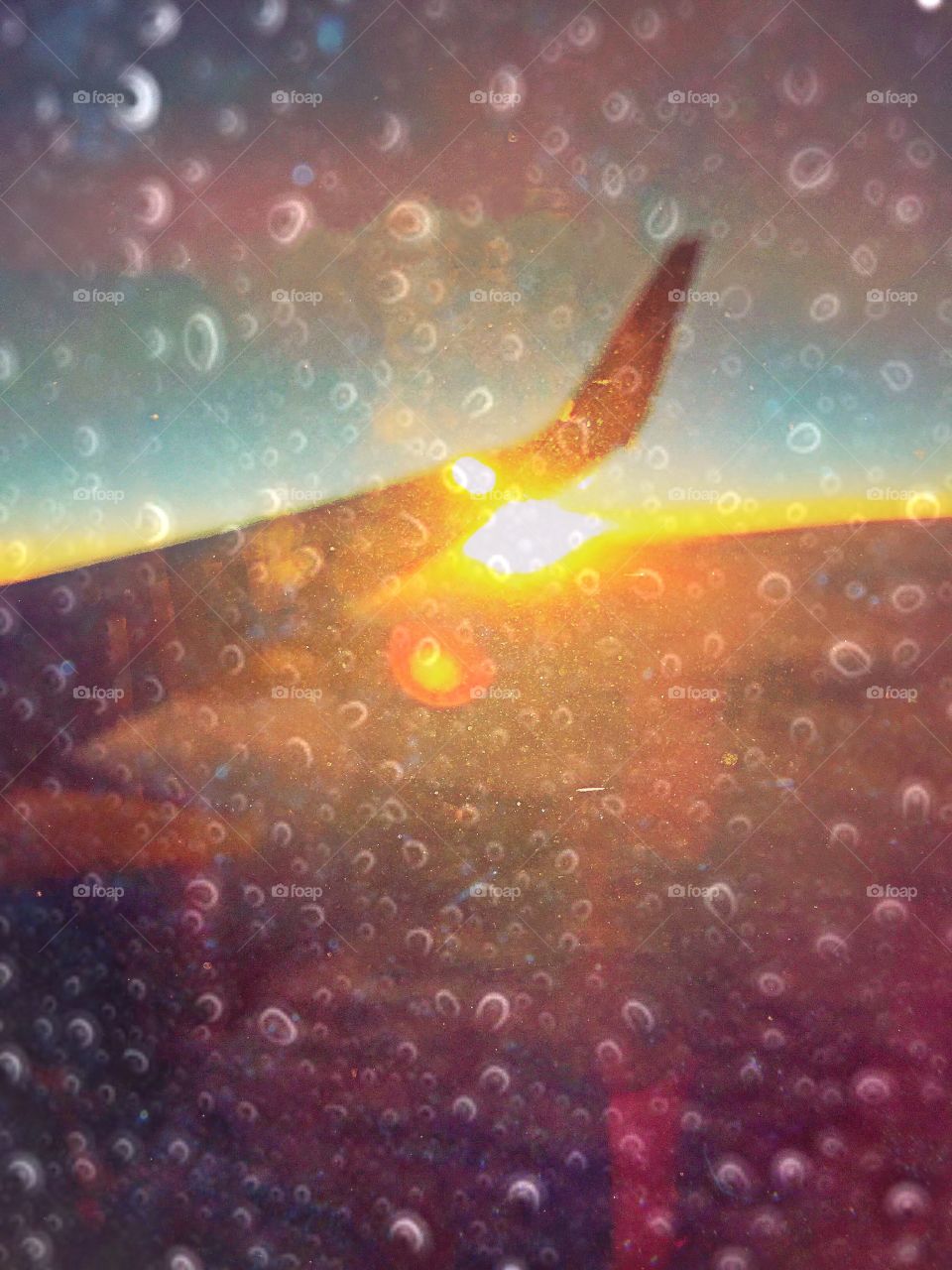 Rain and sun as seen through a jetliner’s window.