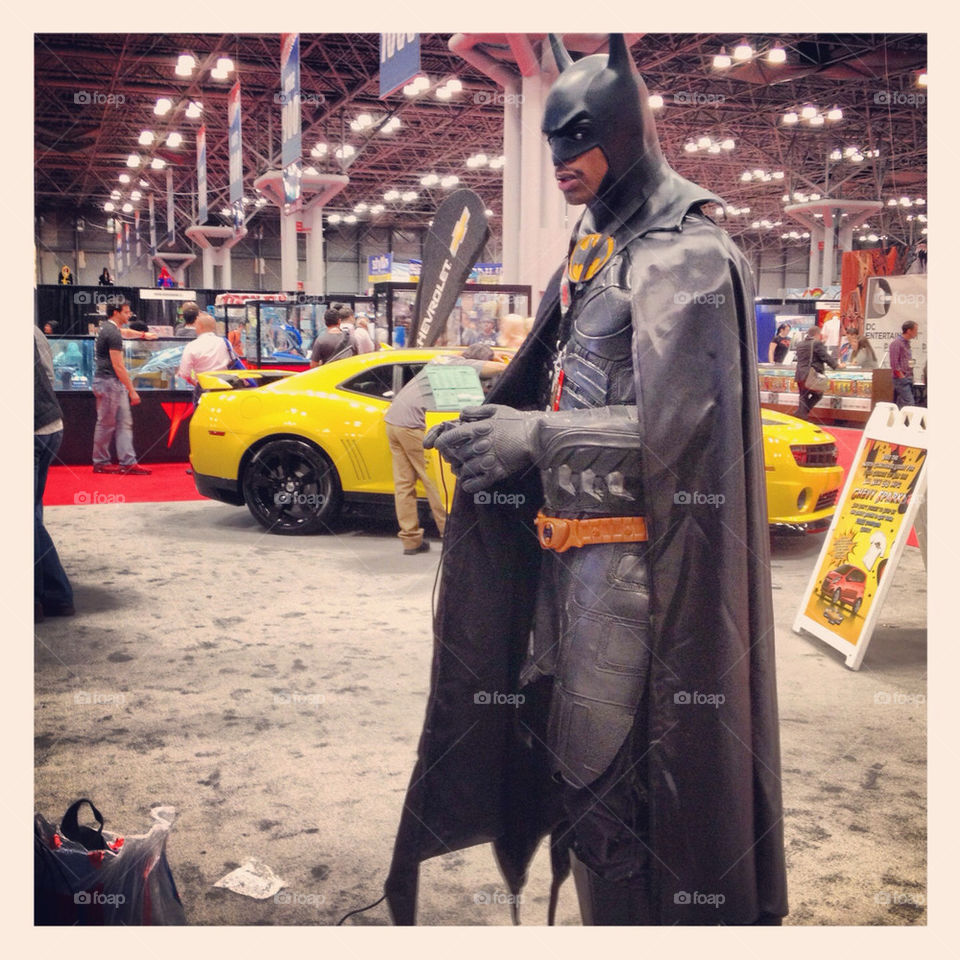 Batman playing video games at the Chevrolet booth at New York Comic