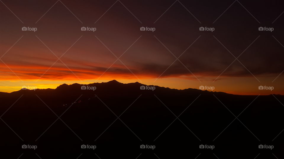 sunset in sky over desert Mountain
