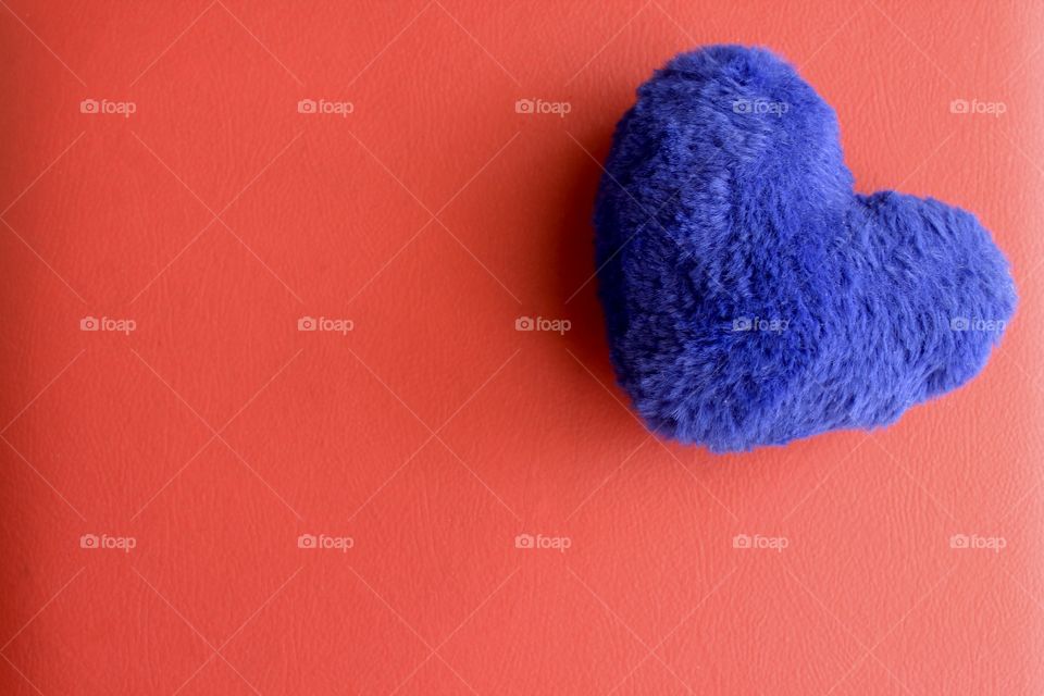 Blue heart on red background