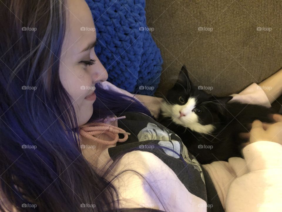 Young girl hugging a kitten