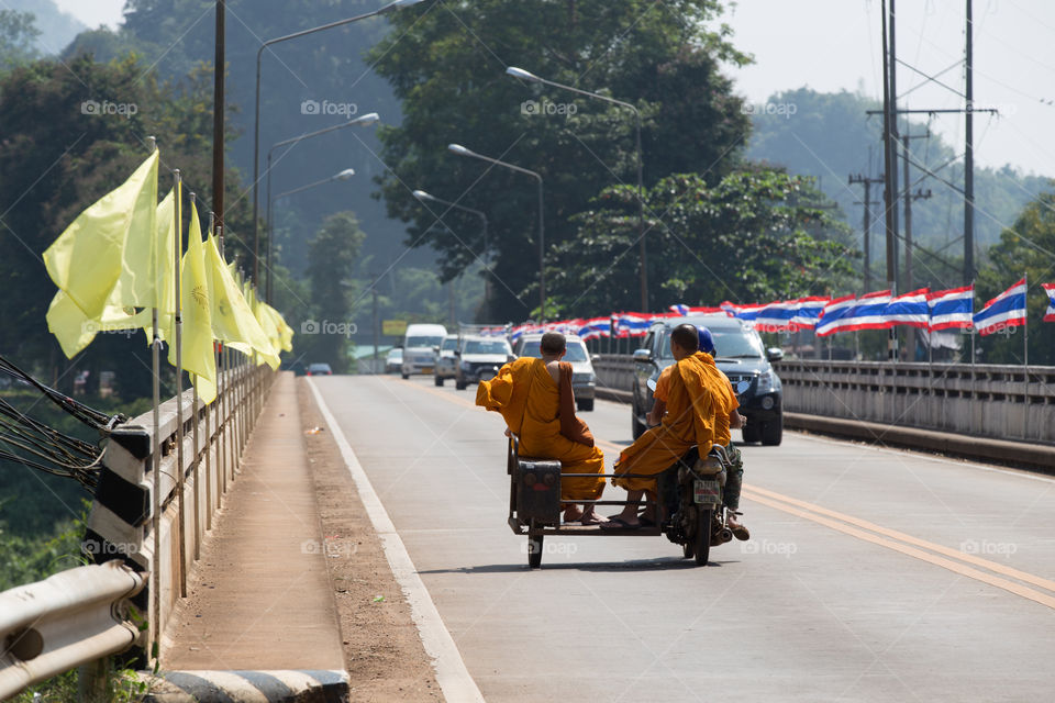 Monk in the motorcycle in the road