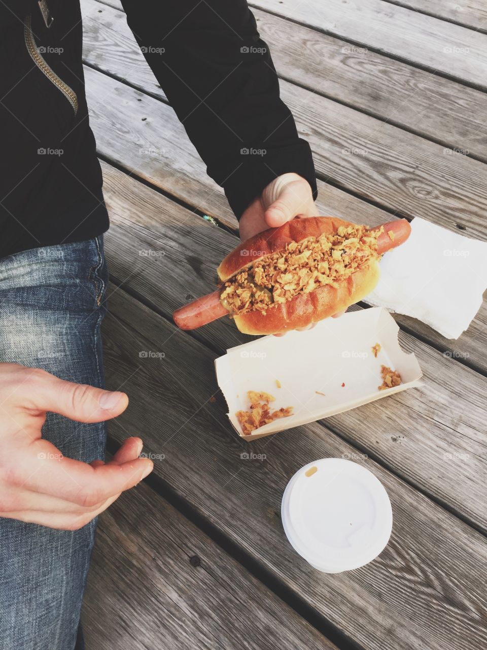 Close-up of person's hand holding hot dog