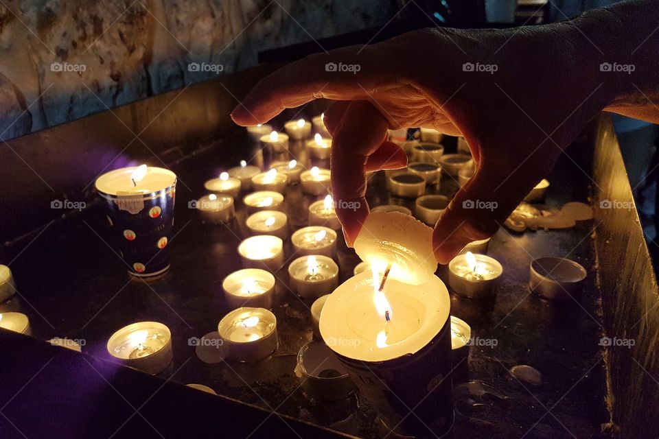 lighting a candle for prayers