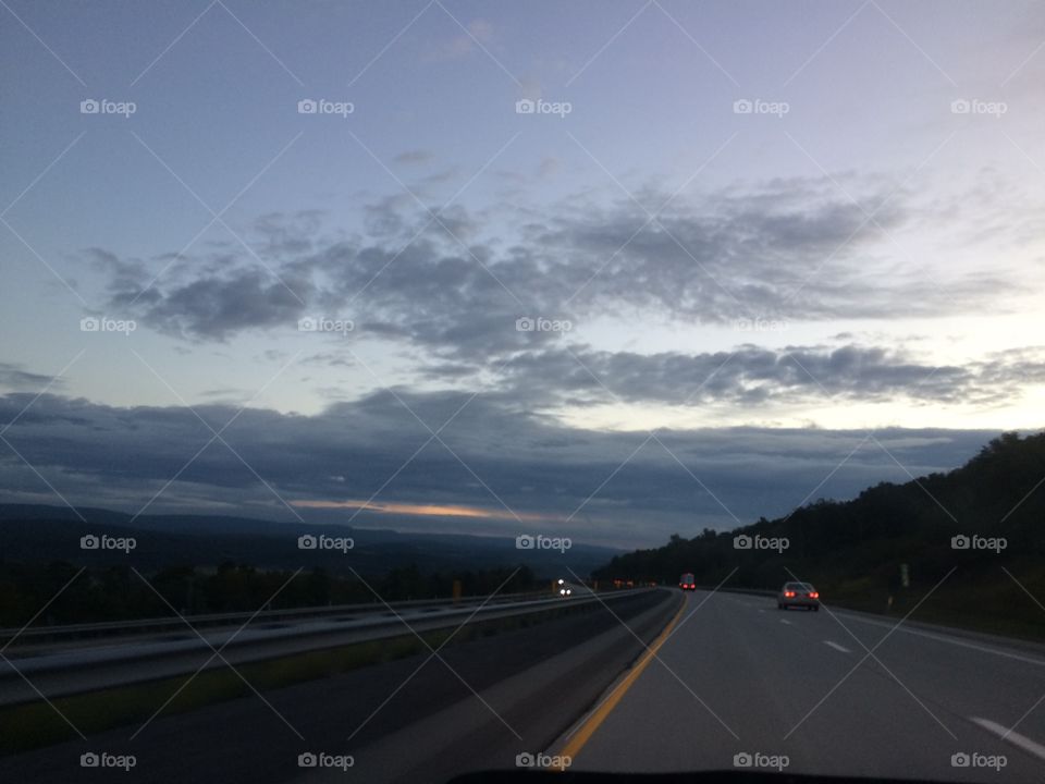 Clouds road trees sky dots morning wake up tired travel driving rushing hauling