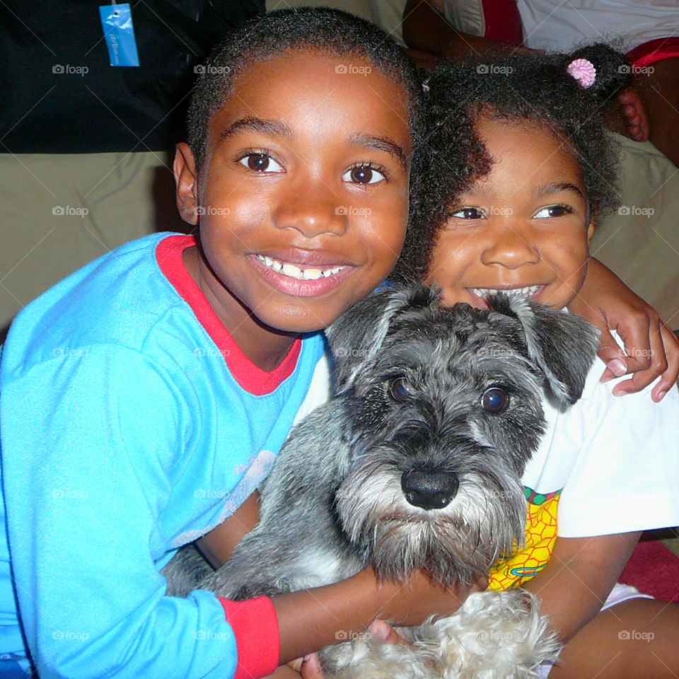 Close-up of brother and sister with their dog
