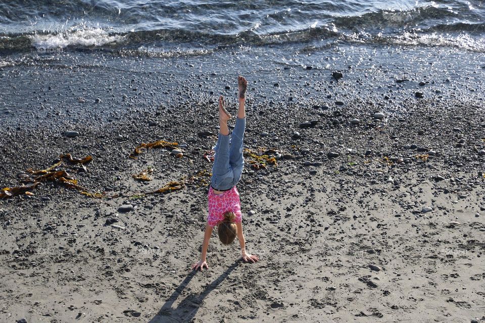 Girl exercising on the beach 