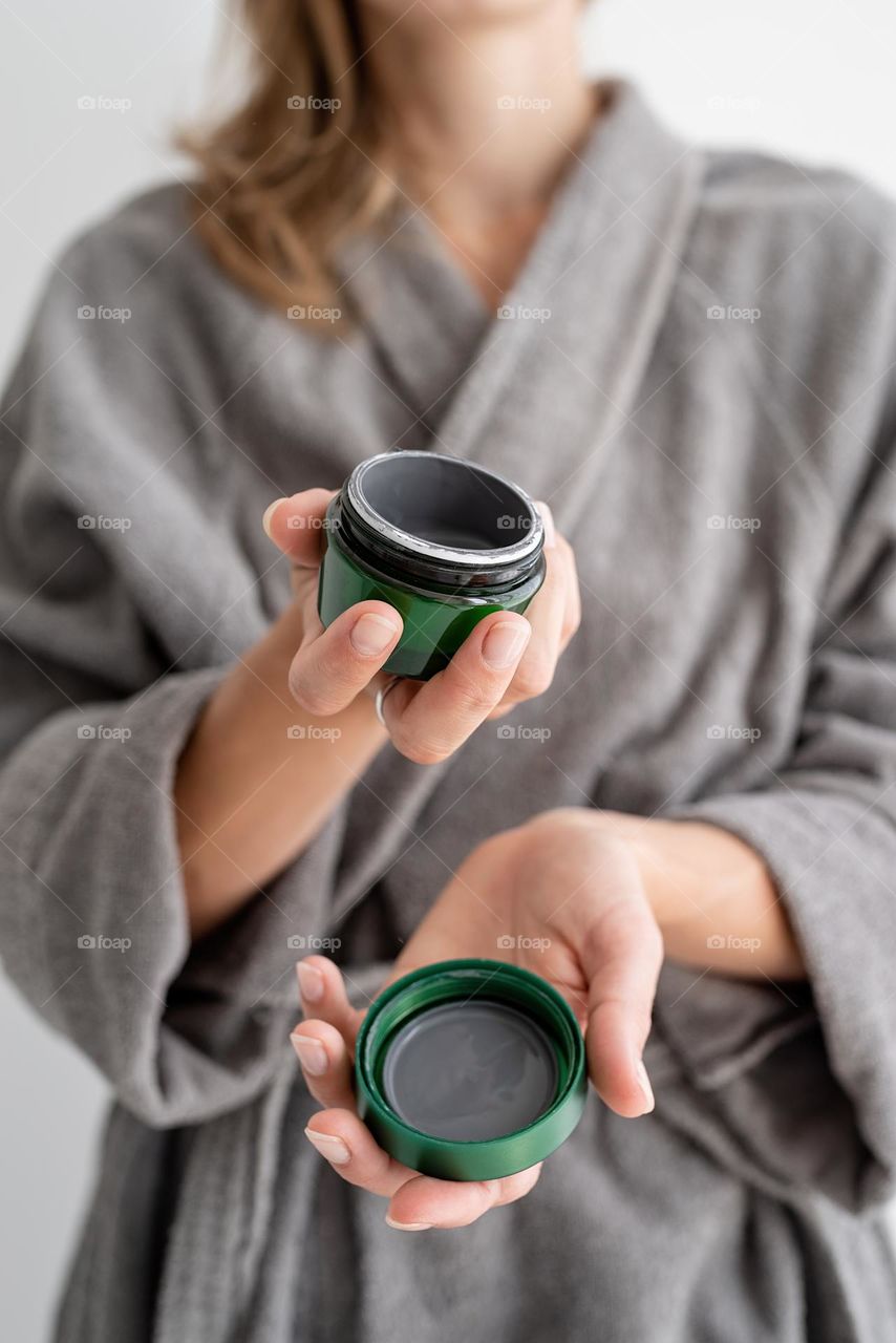 woman hand holding beauty products