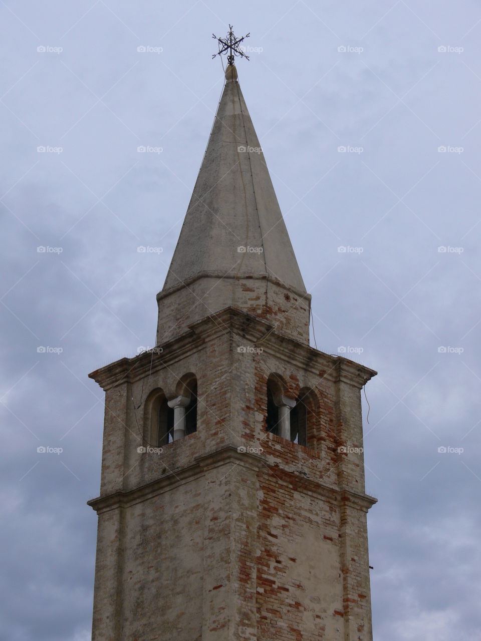 a particular view of the madonna dell angelo church and the lighthouse bell tower at caorle venice italy city seafront cliff