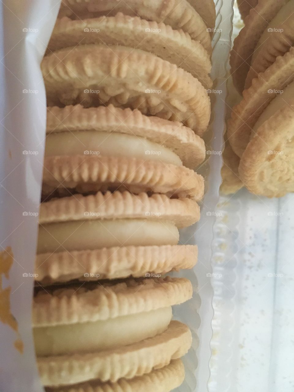 Vanilla Cookie wafers with vanilla filling in a plastic tray with a few missing.