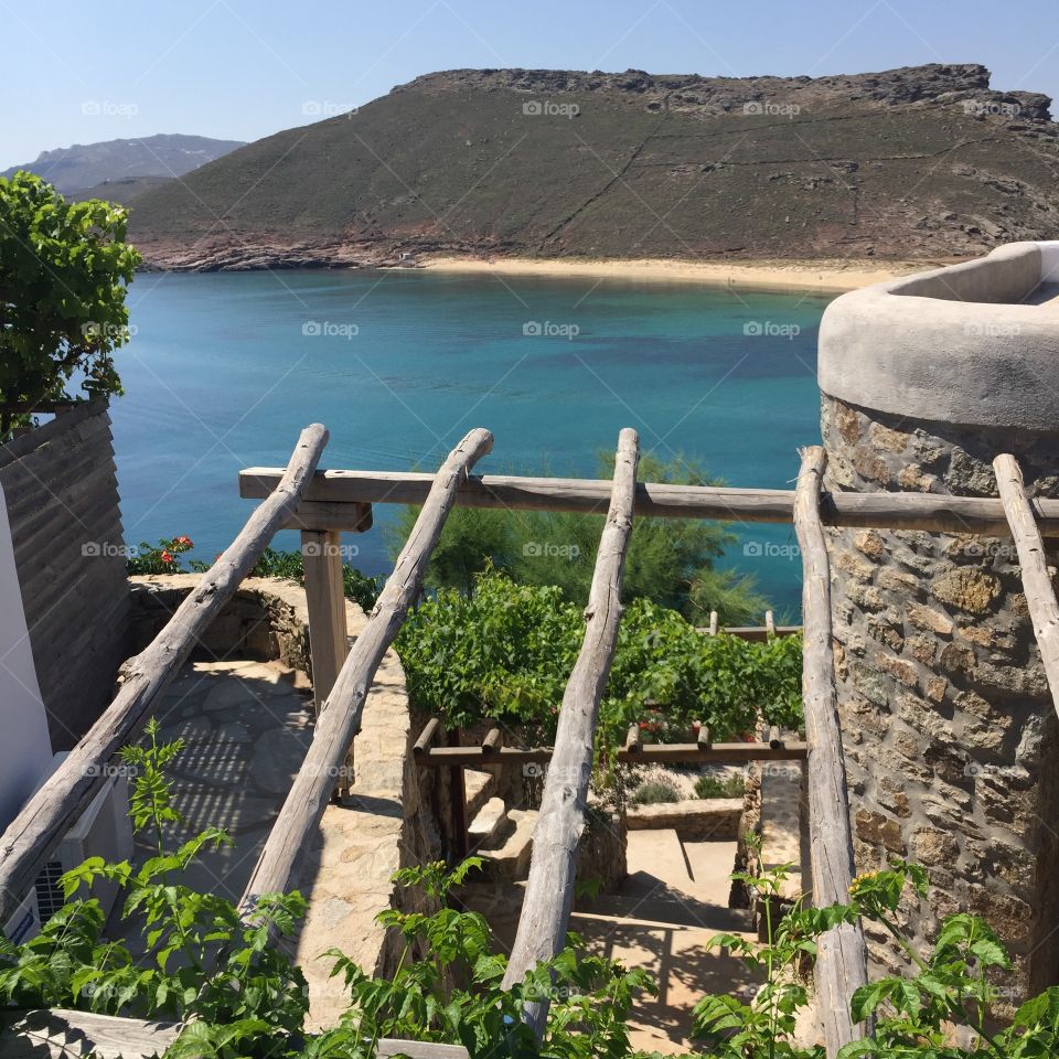 Stone steps leading down to the Aegean Sea in Panomos, Mykonos. 