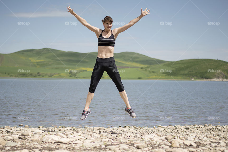 Woman jumping near beach