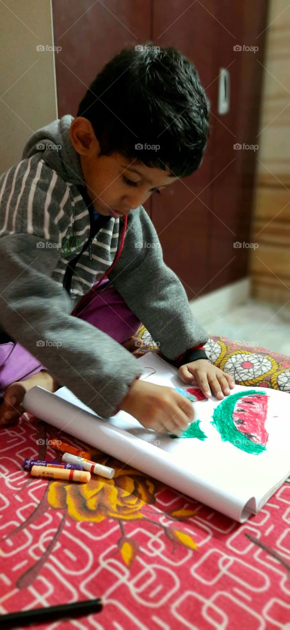 My nephew concentrating hard on his drawing and enjoying it.