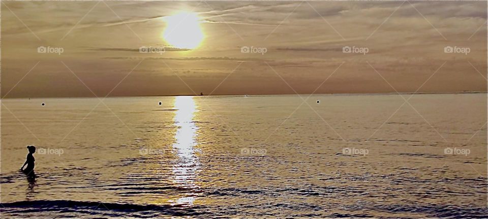 Nothing is quite as intense as a sunset by the “Baltic Sea” by „Warnemünde“ in the former „East Germany“ on a day like this. The ocean shimmers in a shade of bright metallic silver overlaid in gold from the rays of the sun. 2023. Hypnotic Productions