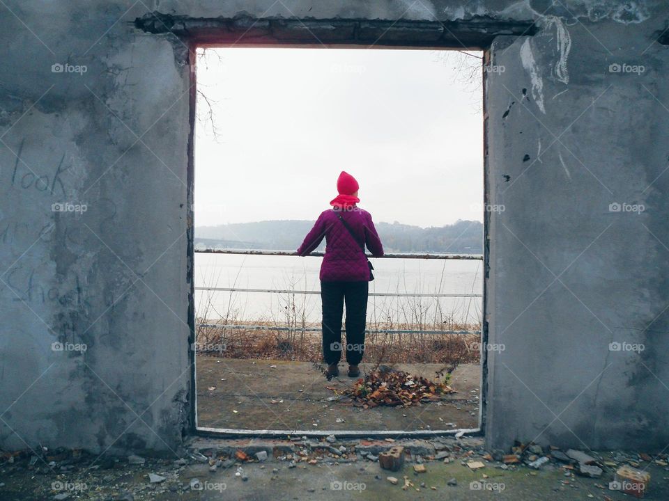 the girl in the doorway of an abandoned building