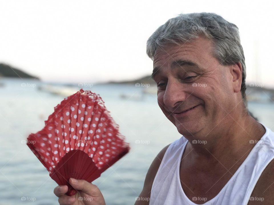 Male, grinning, smiling holding a fan