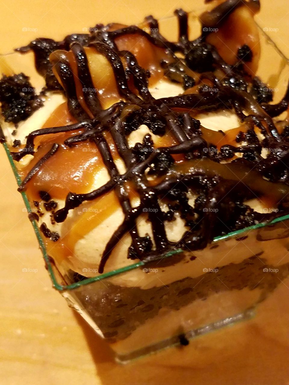 peanut butter chocolate cream dessert topped with caramel and chocolate swirls